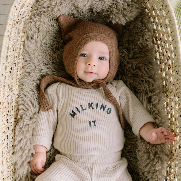 Claude & Co - the Milking It Bodysuit. Soft, cosy against the skin. Knit, organic Cotton, elastane. Popper fastening for easy changing, envelope neck opening to make that inevitable change. Matching leggings or slouchy trousers. Start at 0-3m which makes the ideal gift or first outfit. Dottie and Bee - Olney, Buckinghamshire 