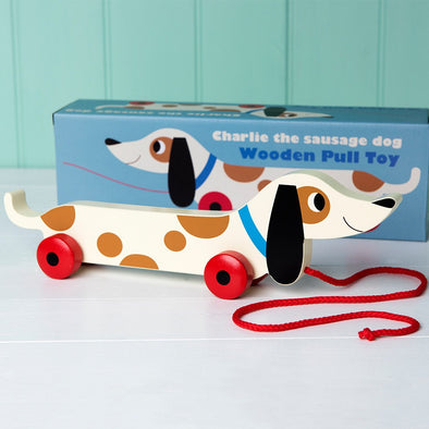 Charlie the sausage dog is a wooden pull along toy from Rex International. The perfect plastic-free toy for children. Ideal for toddlers just starting or are non-stop on the go! Suitable for children over 12 months, this pull along toy is a must have for encouraging those first baby steps . Dottie and Bee - Olney, Buckinghamshire 